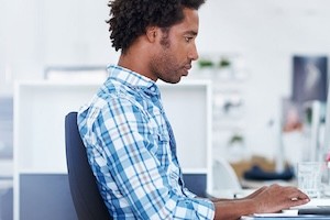Man sitting at desk on laptop