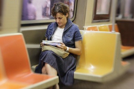 Woman reading on the subway