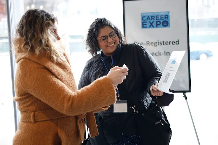 Participants laughing at registration table