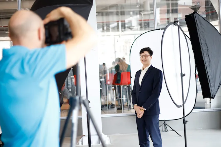 Young man getting photo taken by photographer