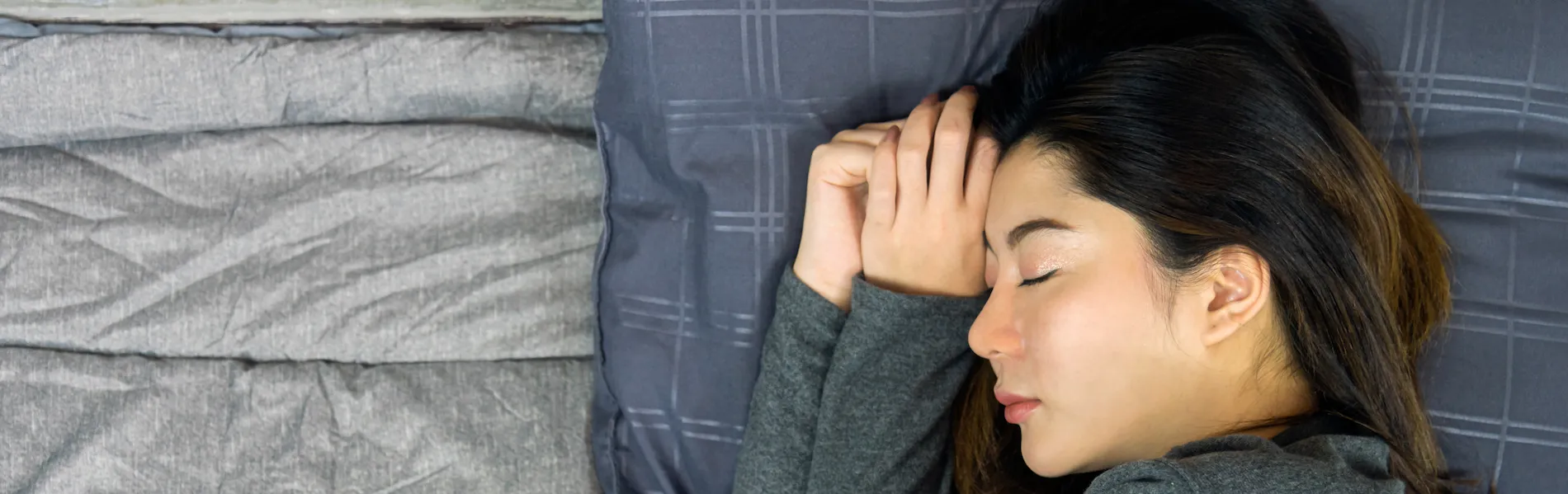 Woman sleeping on pillow on her side